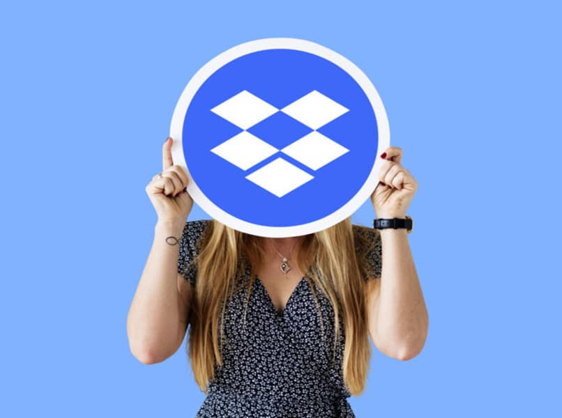 woman covering face with dropbox logo