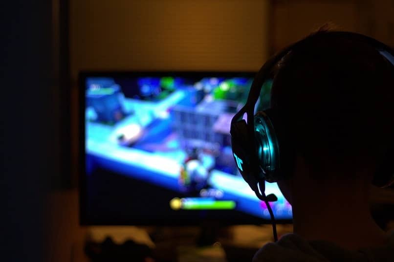 Boy with headphones playing video game
