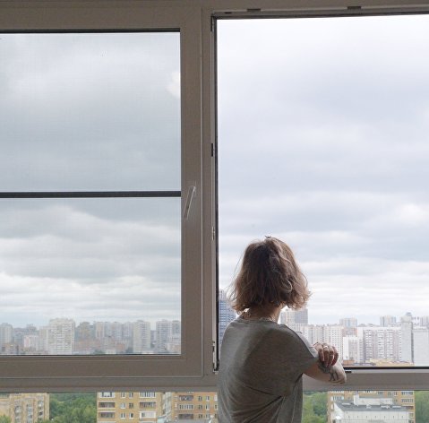 A girl looks out the window in one of the apartments in a multi-storey residential building on 10 A Avangardnaya Street in Moscow, intended for the resettlement of participants in the renovation program.